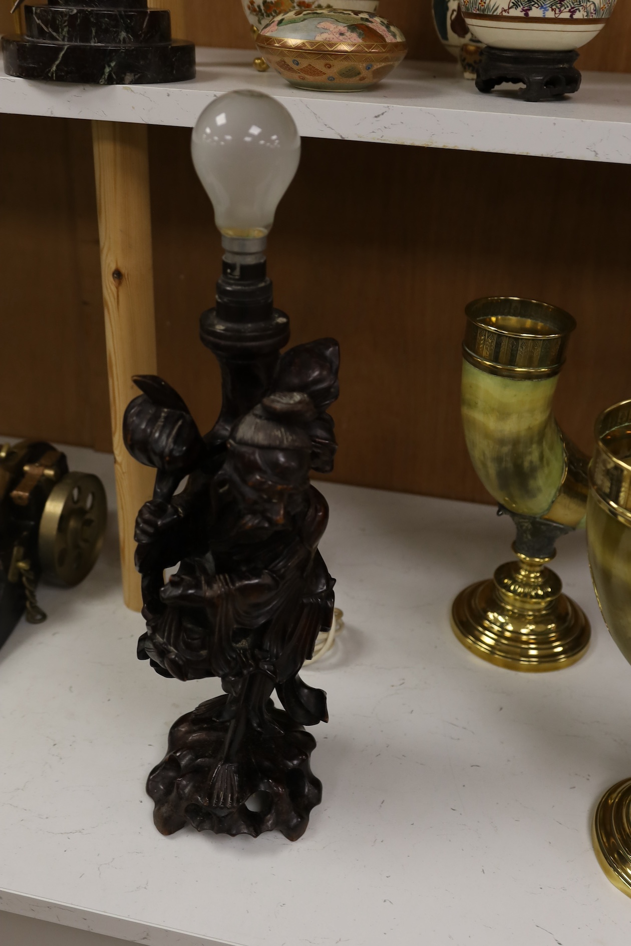 A Chinese carved wooden figural table lamp base, 36cm high not including light fitting. Condition - rubbed in places